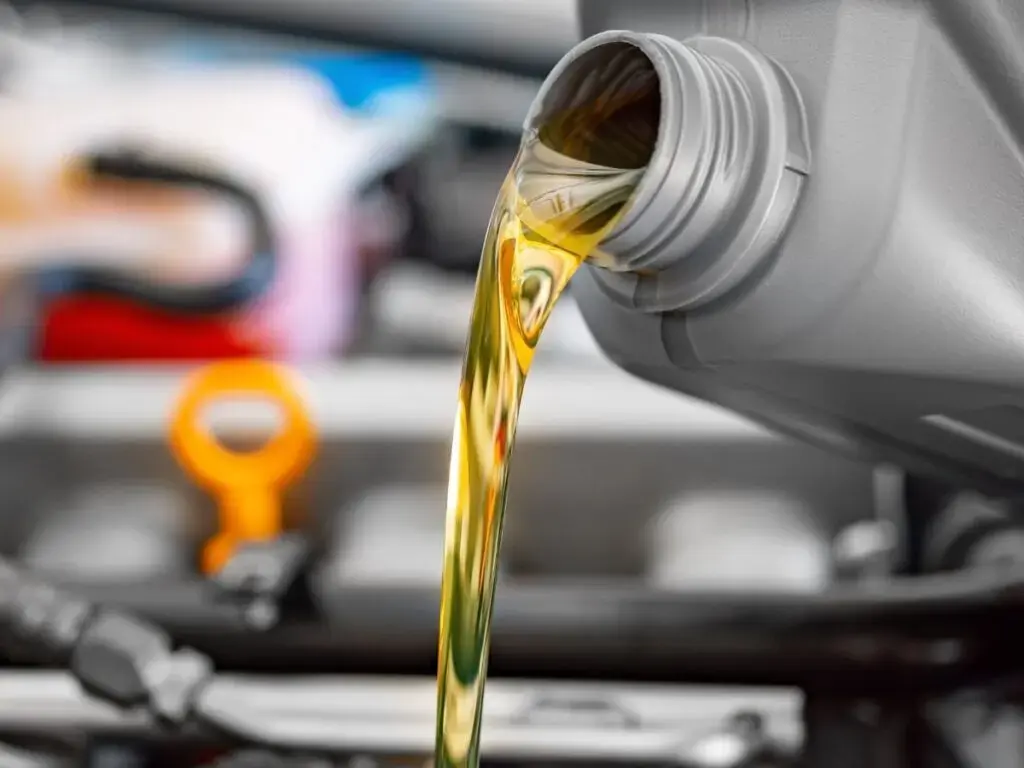 pouring oil into the engine